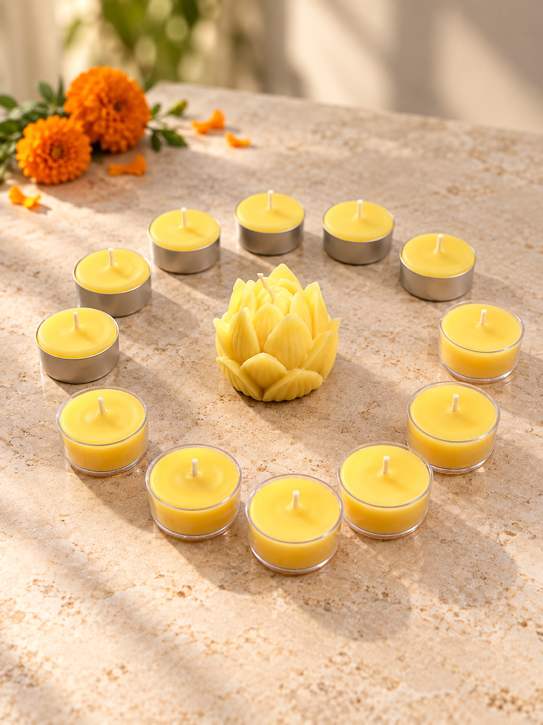 Golden beeswax lotus candle surrounded by 12 clear-cup tea lights